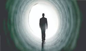 Man walking into light