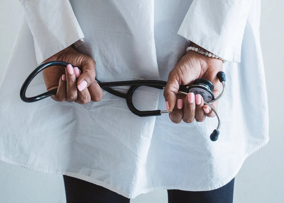 woman holding sthesthoscope behind her