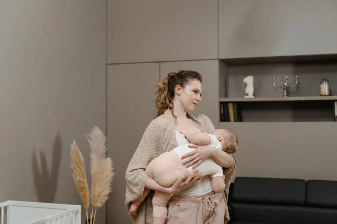 White woman carrying her baby, about to breastfeed her child breastmilk