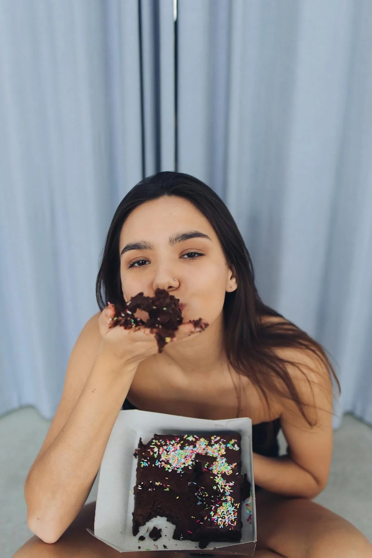 Woman eating cake on the floor